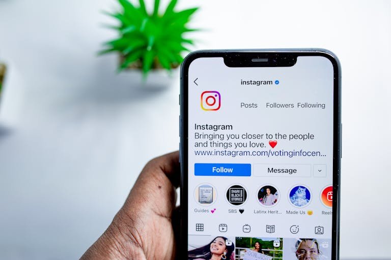 Close-up of a smartphone displaying the Instagram app, emphasizing social media connection.